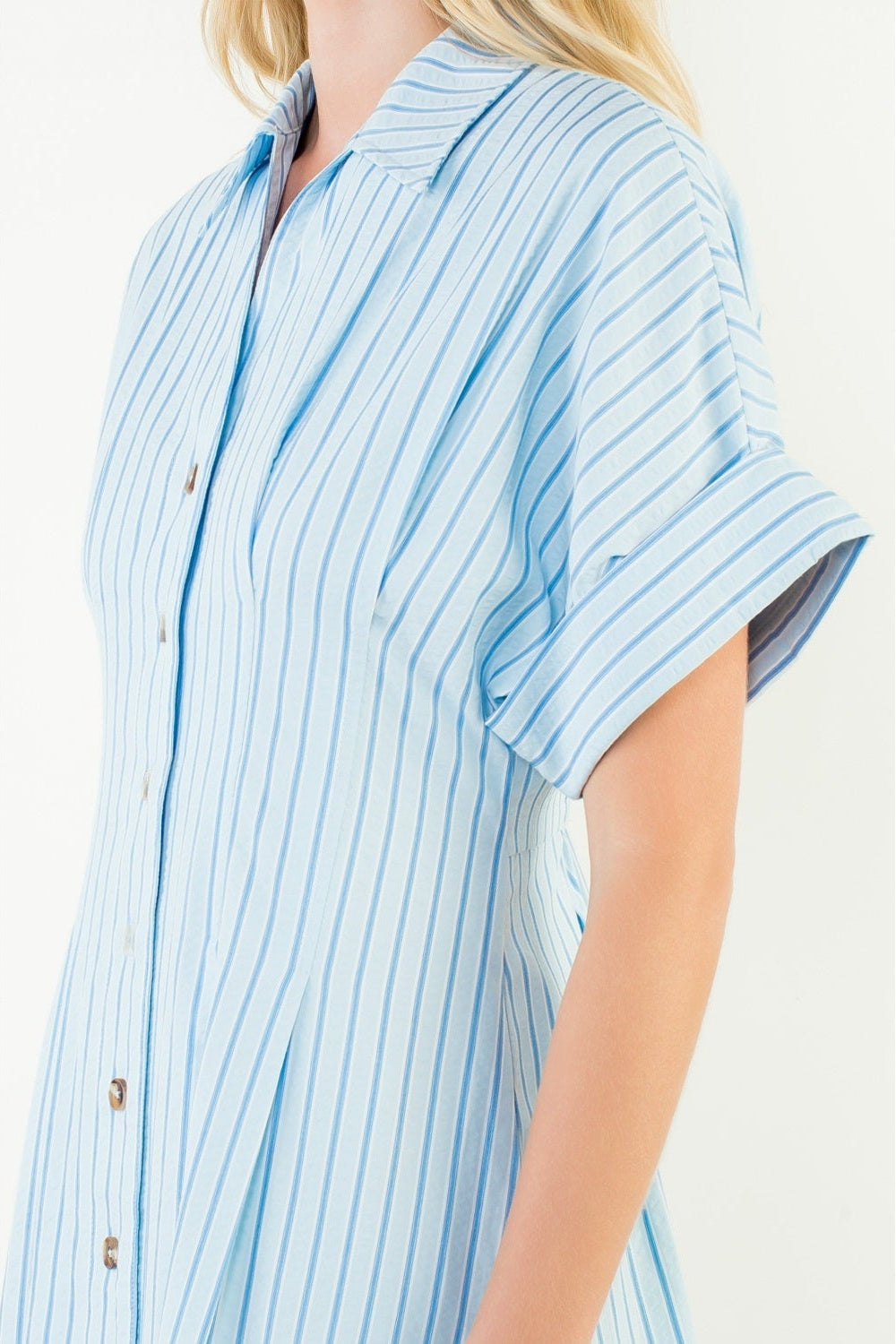 Person wearing a blue and white striped shirt on a white background