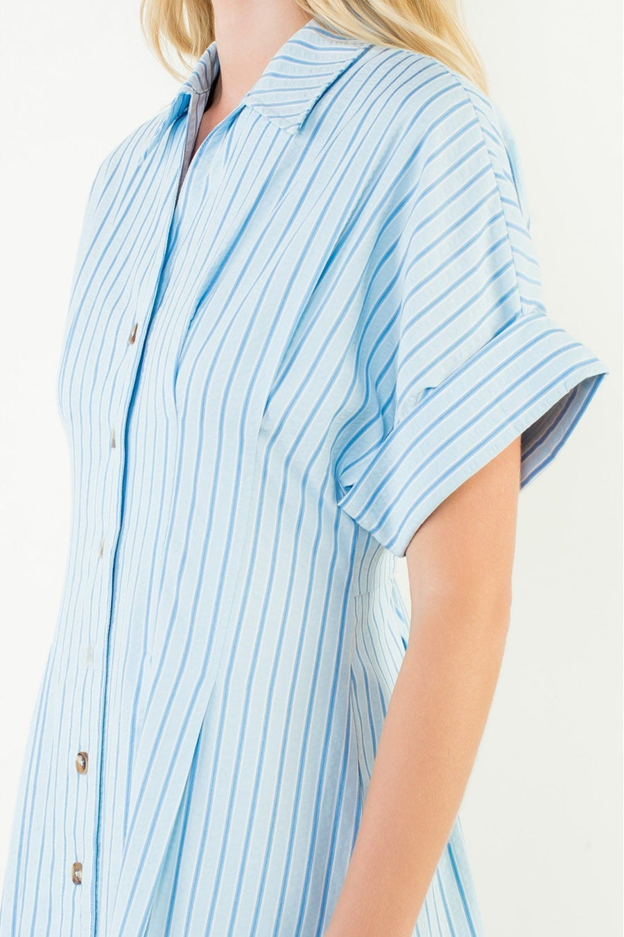 Person wearing a blue and white striped shirt on a white background