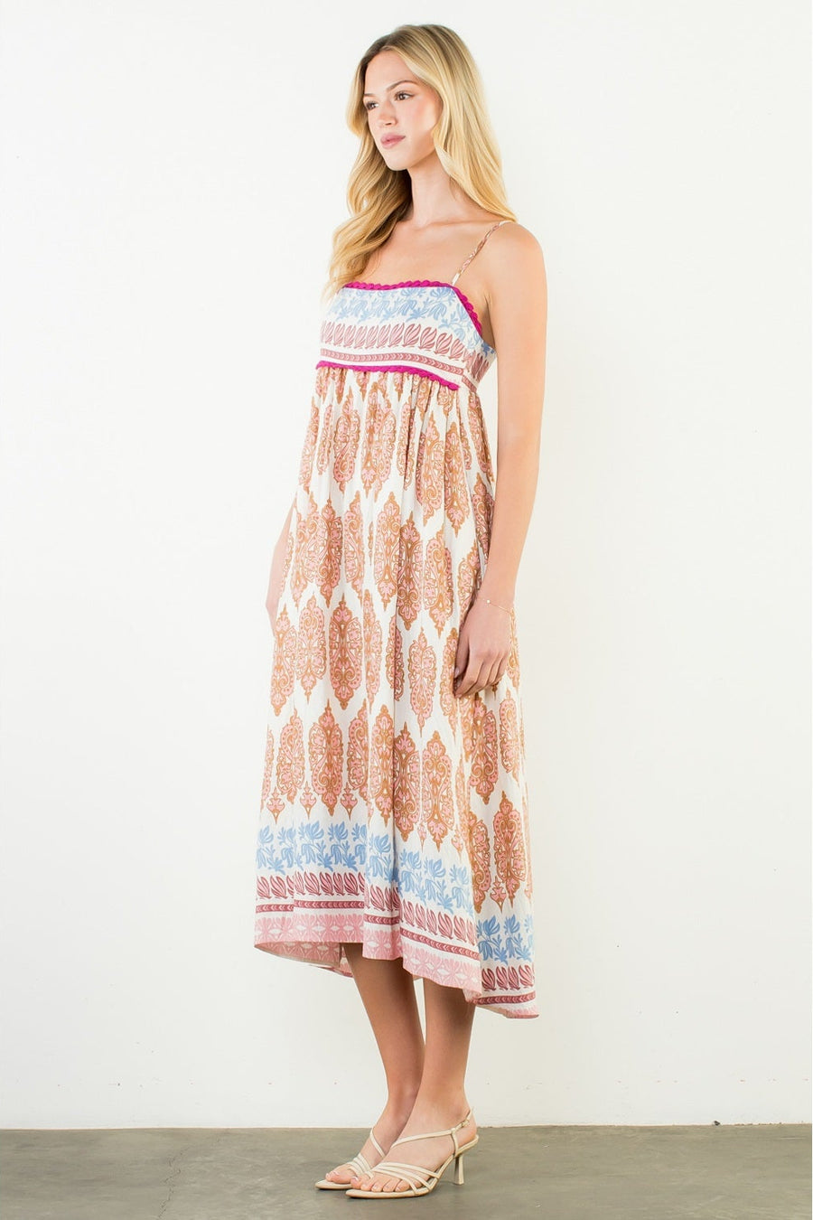 Woman wearing a strapless dress with a geometric pattern on a white background