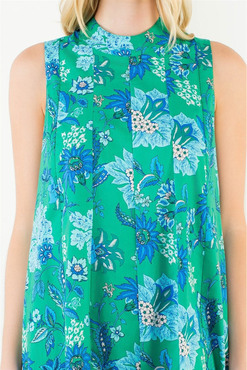Green sleeveless dress with blue floral pattern on a white background