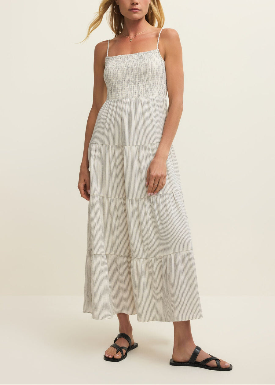 Woman wearing a white dress on a plain background