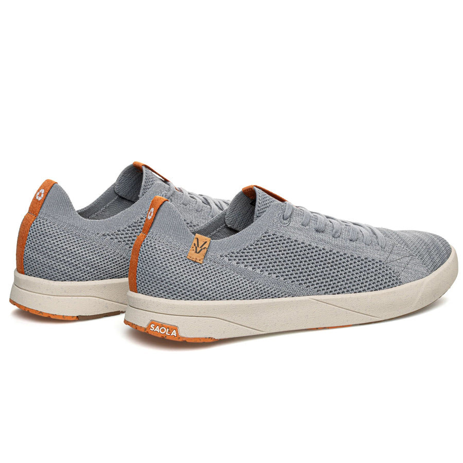 Gray sneakers with orange accents on a white background