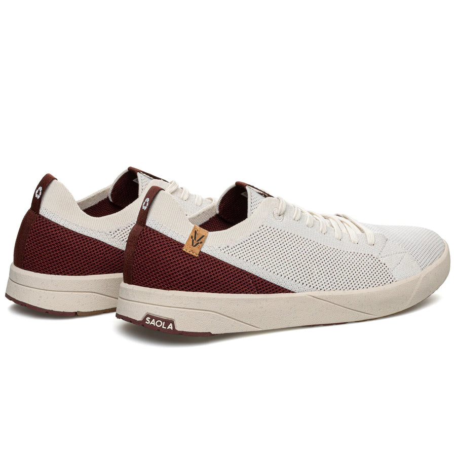 Pair of white and burgundy sneakers on a white background