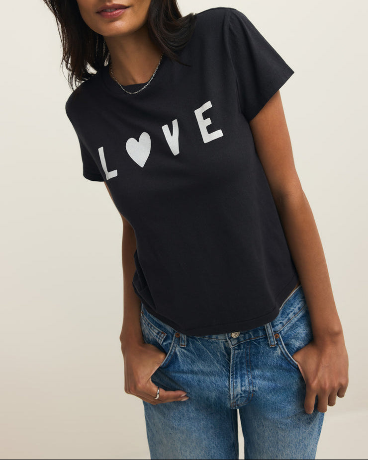 Woman wearing a black t-shirt with 'LOVE' printed on it against a plain background