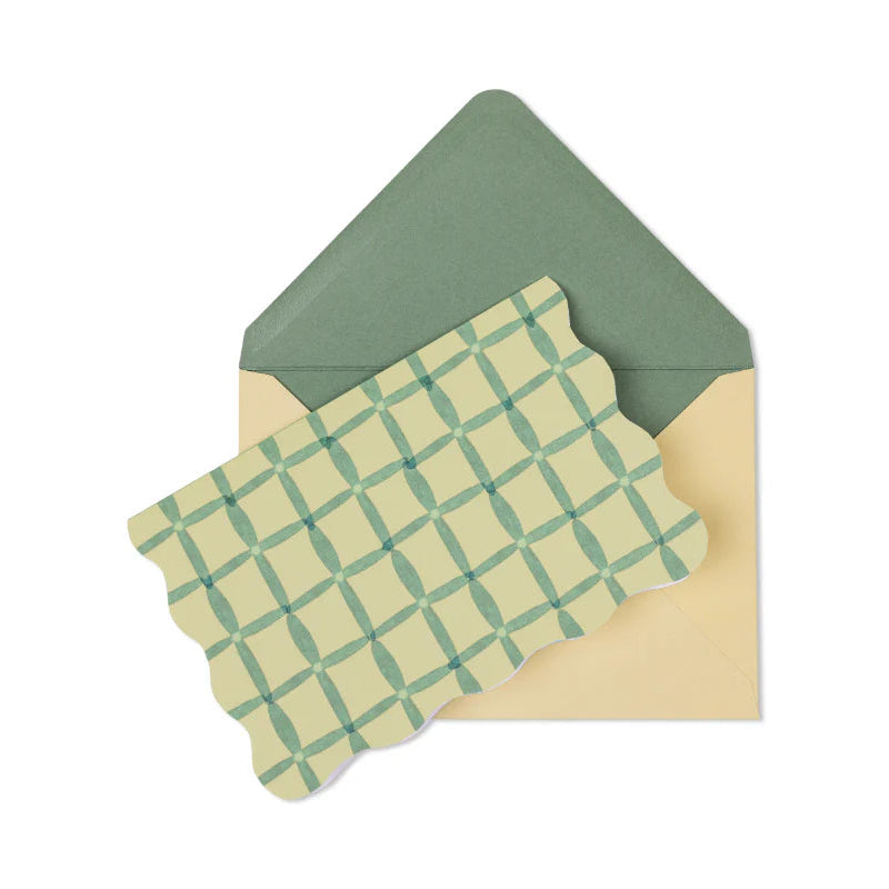 Green checkered card inside a green envelope on a white background