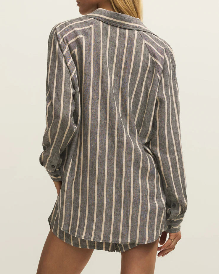 Person wearing a striped shirt against a plain background