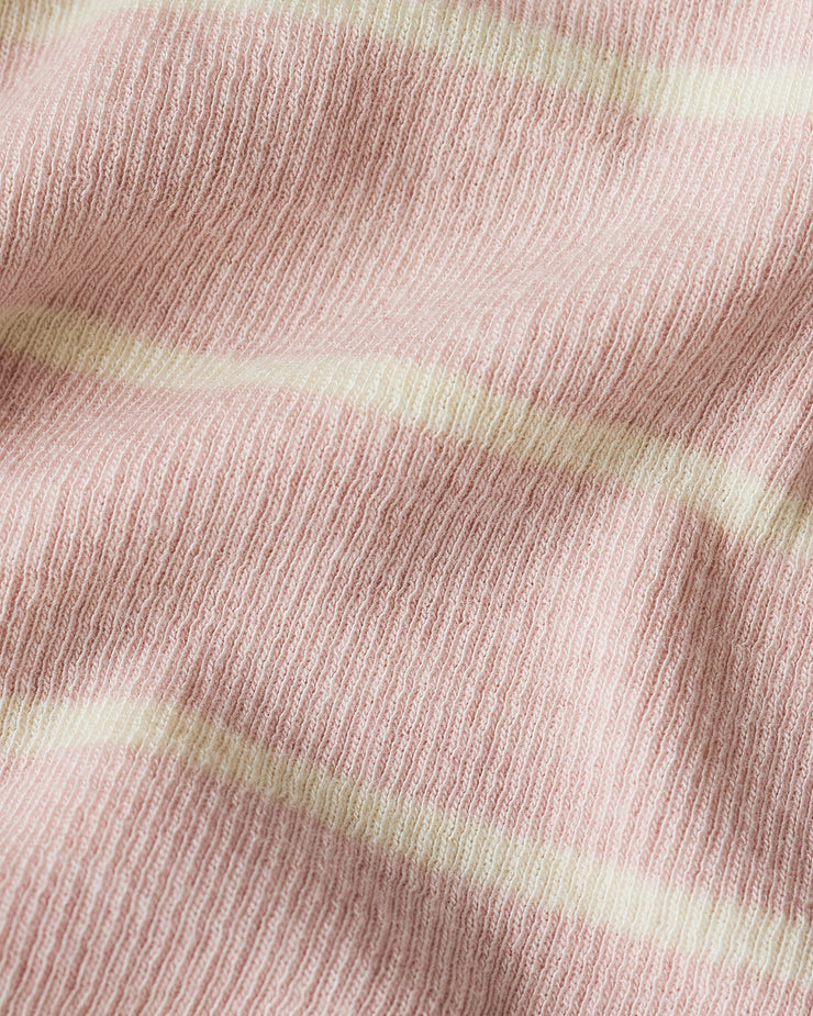 Close-up of pink fabric with subtle texture and light green stripes.