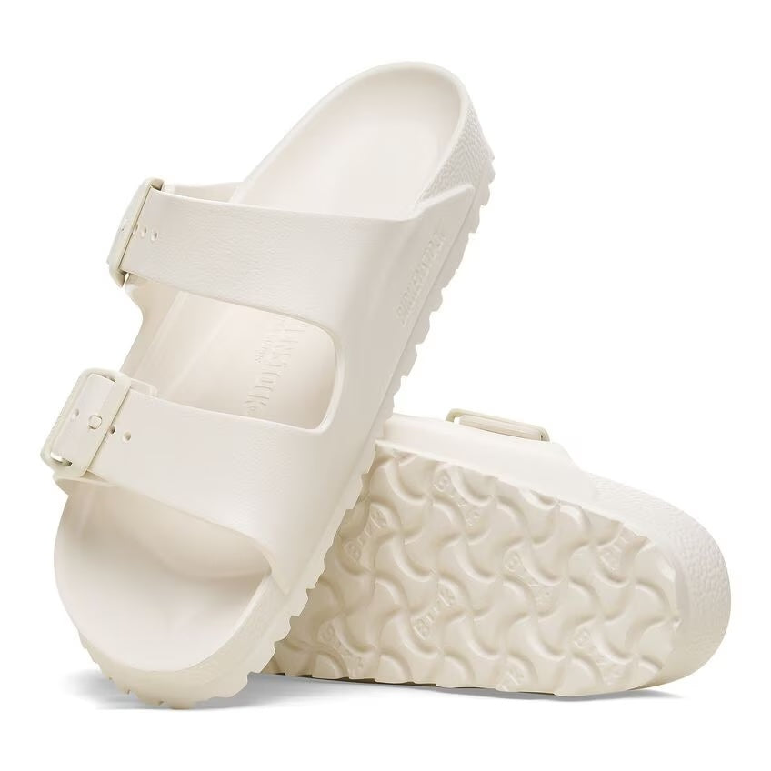 A pair of Birkenstock Arizona EVA sandals in white color with two adjustable straps and a contoured footbed.