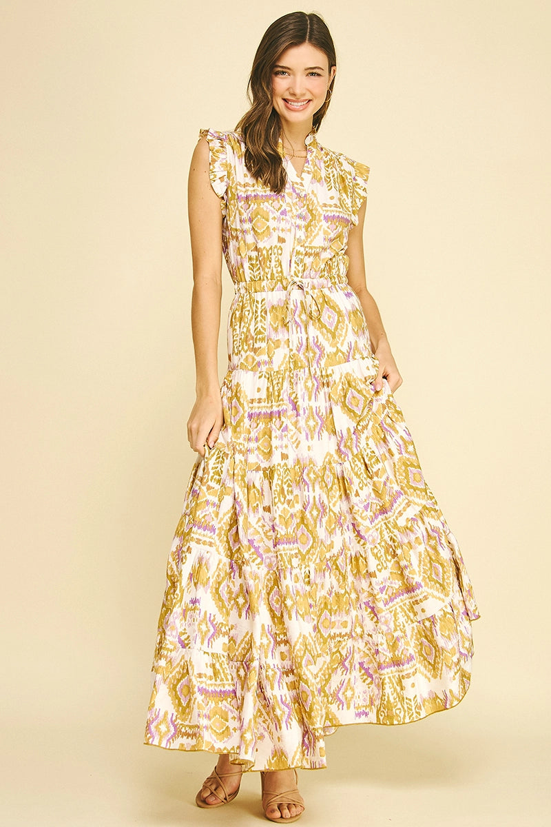 Woman wearing a yellow and white patterned dress on a beige background
